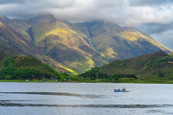 Fishing boat against Kintail mountains, Ratagan, Lochalsh, Scottish Highlands, Scotland, UK