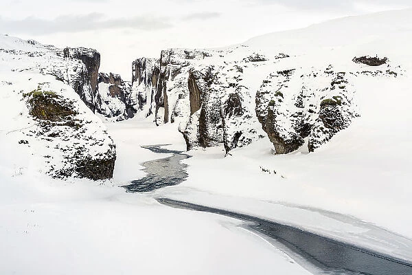 The Fjadrargljufur Canyon covered by ice and snow, Iceland