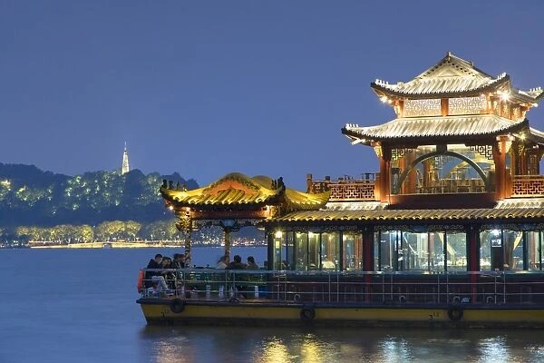 Floating restaurant on West Lake (UNESCO World Heritage Site) at dusk, Hangzhou, Zhejiang