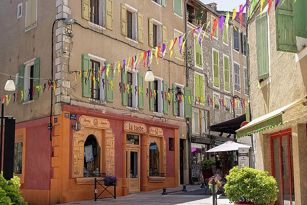 France, Provence-Alpes-Cote d'Azur, Sisteron, a colourful street and shop fronts in Sisteron town