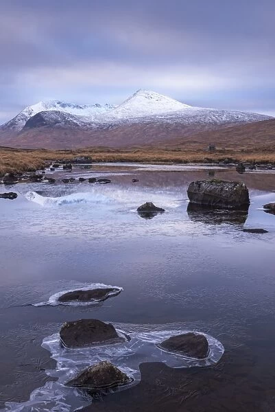 Frozen lochan reflecting the Black Mount, Rannoch Moor, Scotland. Winter (November)