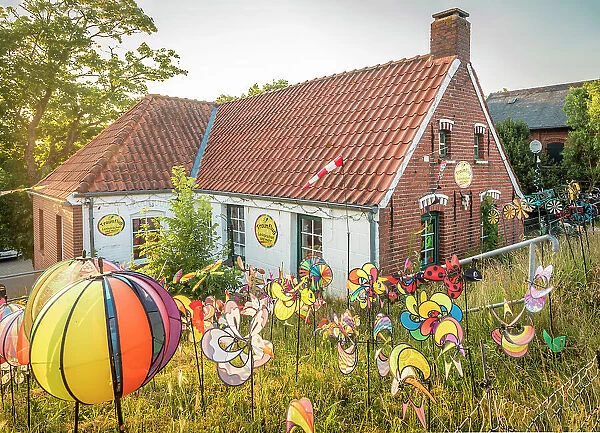 Funny colorful wind chimes at the dike house in Greetsiel, East Frisia, Lower Saxony, Germany