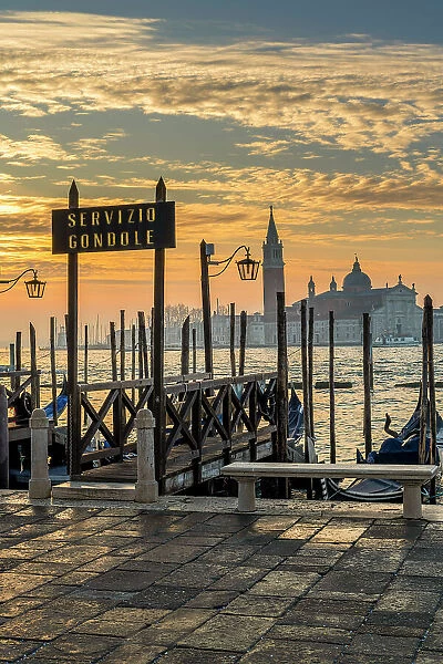 Gondola service sign and Church of San Giorgio Maggiore in the background at sunrise Venice, Veneto, Italy