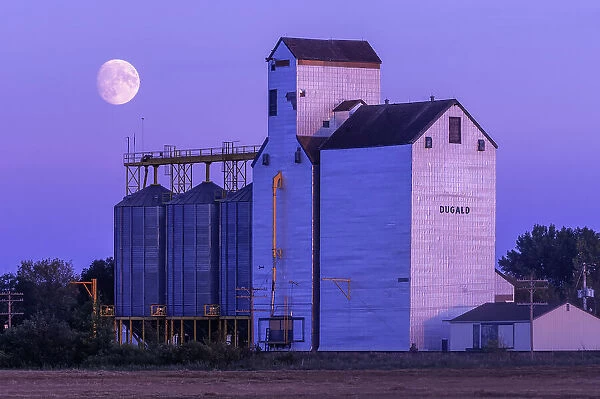 Grain elevator and full moon. Duglad, Manitoba, Canada
