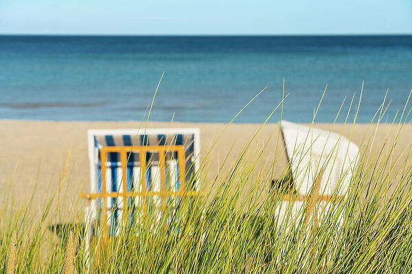 Grass with beach chairs on beach in background, Boltenhagen, Nordwestmecklenburg, Mecklenburg-Western Pomerania, Germany