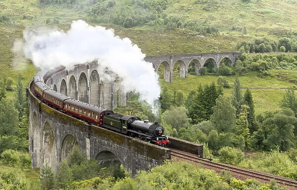 Historic steam train The Jacobite on the Glenfinnan Viaduct, Highlands, Scotland