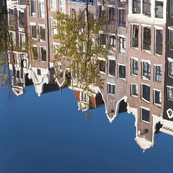 Holland, Amsterdam, traditional Gabled houses reflected in canal