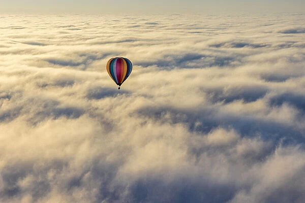 Hot air balloon above low cloud, Yarra Valley, Victoria, Australia
