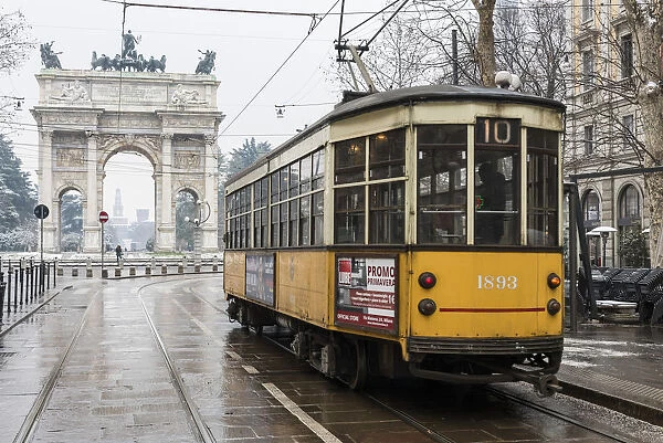 Iconic tramway with Arch of Peace in the background. Milan, Lombardy, Italy