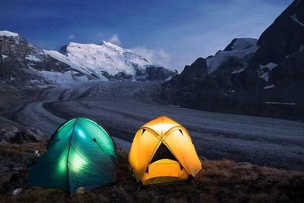 Illuminated tents by nigh camping close to the Grand Combin glacier, Grand Combin