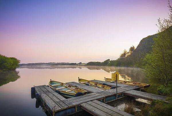 Ireland, Co. Donegal, Fanad, Kindrum, rowing boats on lake at dawn