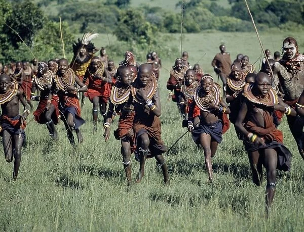 A jovial group of Msai girls are chased by warriors during a ceremony