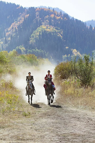 Kazakhstan, Almaty, a couple of Kazakhs ride their horses
