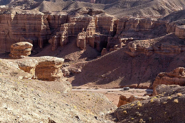 Kazakhstan, Charyn Canyon, an old bus drives through the canyon