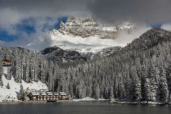 Lake Misurina with Tre Cime di Lavaredo or Drei Zinnen behind partially covered by clouds