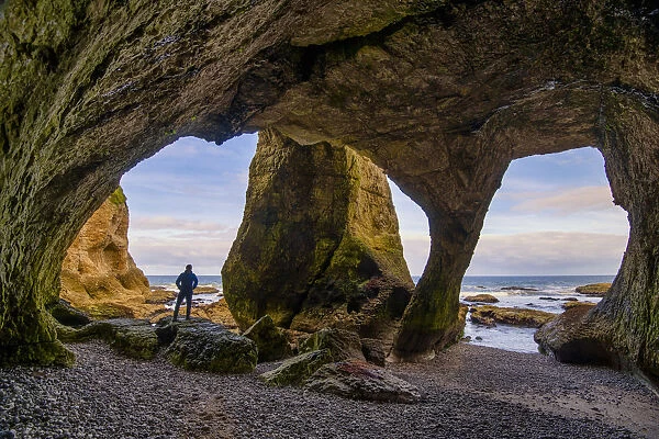 Man in Cathedral Cave, Co. Antrim, Northern Ireland