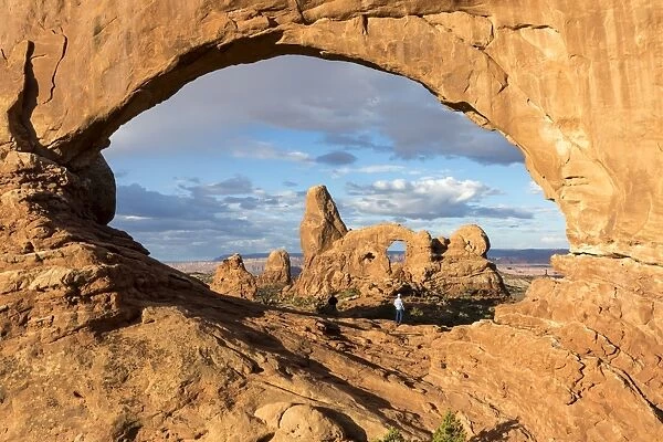 Man overlooking Turret Arch from North Window. Arches National Park, Moab, Grand County