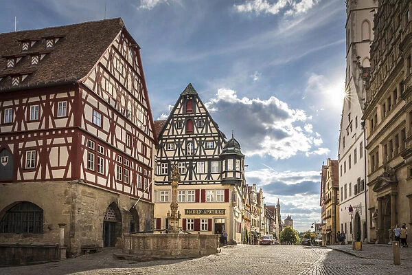 Market Square fountain and historic houses in Herrngasse in the old town of Rothenburg ob