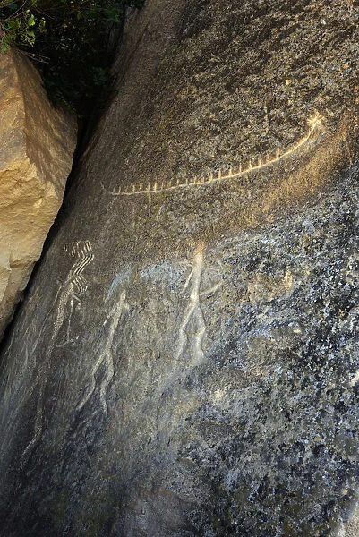 Men and a boat rock engravings. Gobustan Rock Art Cultural Landscape Reserve has an