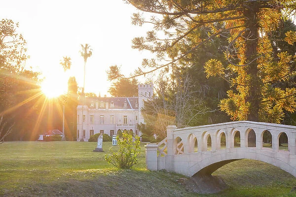 The monumental garden of La Candelaria Estancia & Polo Club at sunset, with the castle in background, Lobos, Buenos Aires province, Argentina