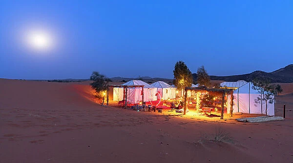 Full moon over berber tents in a desert camp, Erg Chebbi, Merzouga, Sahara Desert, Morocco