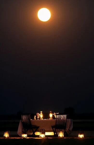 Moonlit dinner on an island in the middle of the Zambezi River