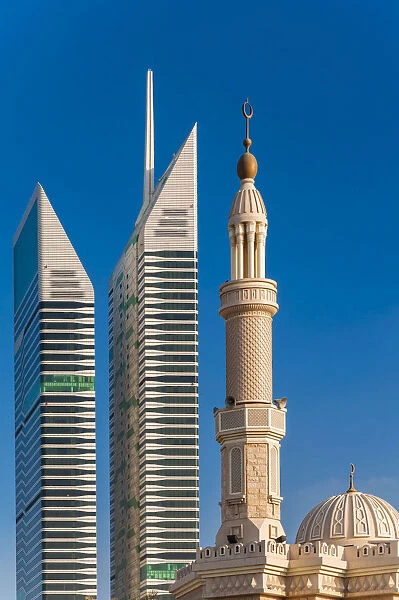Mosque minaret with skyscrapers in the background, Dubai, United Arab Emirates