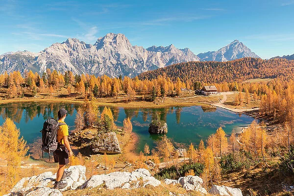 A mountaineer staring at Federa Lake with the Dolomite mountains in the background, Dolomites, Municipality of Cortina d'Ampezzo, Belluno province, Veneto, Italy