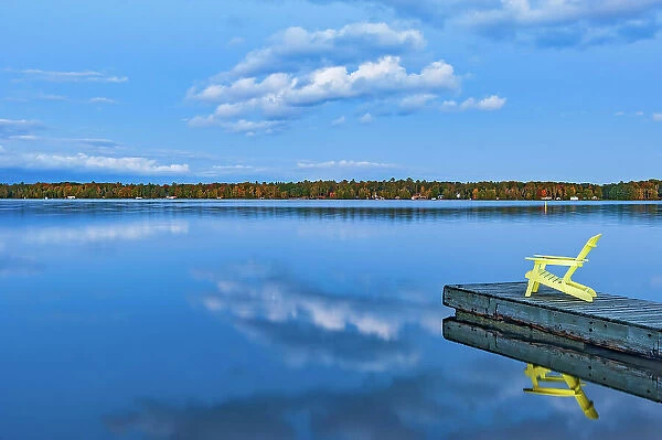 Muskoka chair on dock of Silent Lake at dusk Silent Lake Provincial Park, Ontario, Canada