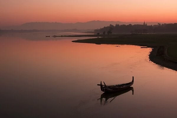 Myanmar, Burma, Amarapura. Sunrise at Taungthaman Lake, Amarapura, with Kyauktawgyi Pagoda just visible above