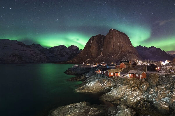 Northern lights in the sky over the village. Hamnoy, Nordland county, Northern Norway