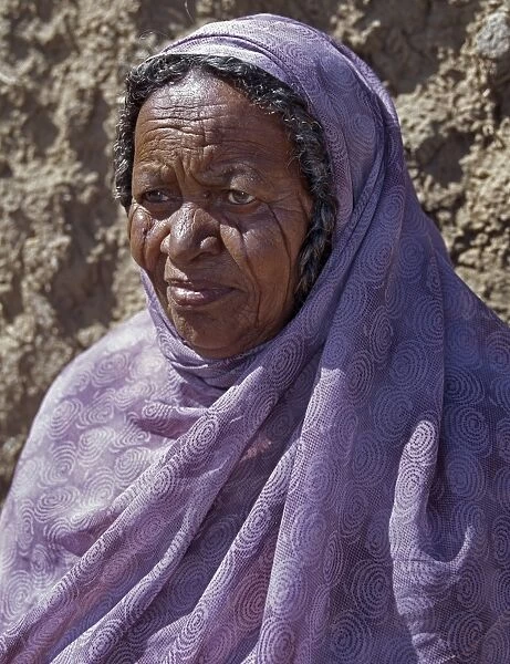 Nubian women wear bright dresses and headscarves even