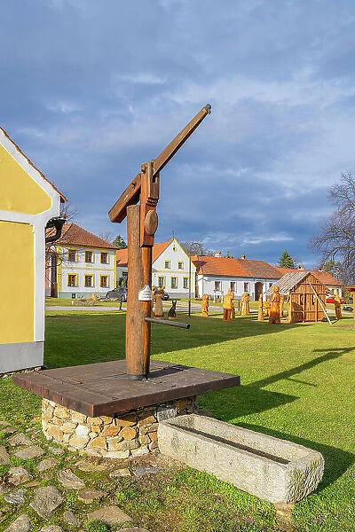 Old wooden pump at Holasovice square, UNESCO, Jankov, Ceske Budejovice, South Bohemian Region, Czech Republic