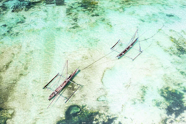 Overhead view of dhow boats moored in the emerald green water of lagoon, Paje, Jambiani, Zanzibar, Tanzania