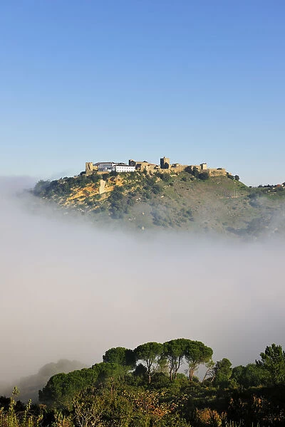 Palmela medieval castle in a misty morning. Portugal
