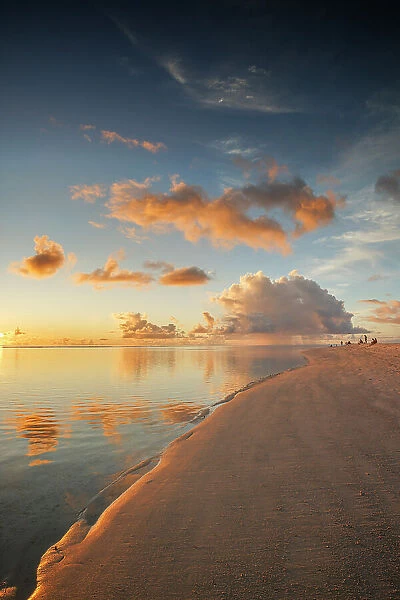 People enjoying the sunset on the sandbank at on a tropical island, North Ari Atoll, the Maldives