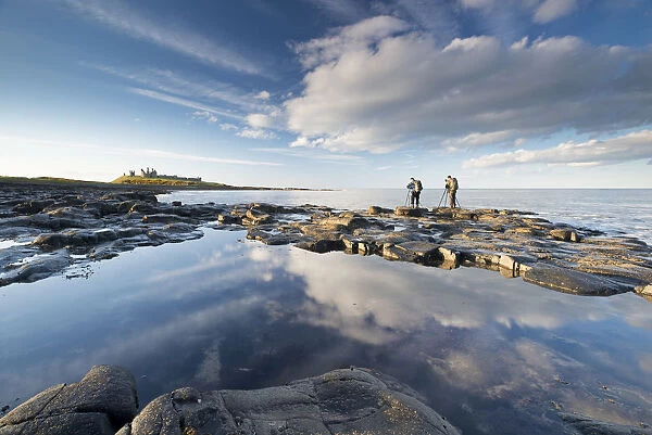 Photographers on the coast near Dunstanburgh Castle, Northumberland, England. Spring