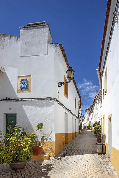 Portugal, Alentejo, Elvas. View along an ancient whitewashed Moorish street in the castle