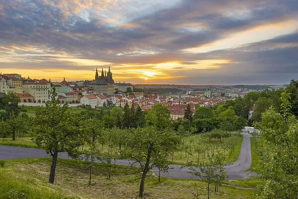 Prague castle in city against cloudy sky at sunrise, Prague, Bohemia, Czech Republic