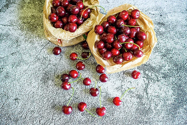 Red cherries ready to eat on a table, high angle view