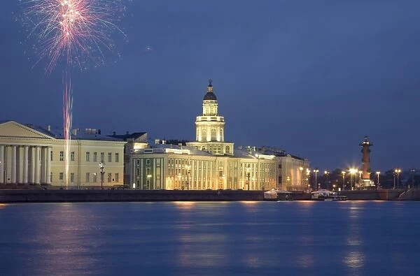 Russia, St. Petersburg; Across the Neva River with the Kunstkamera and a Rostral column while fireworks are