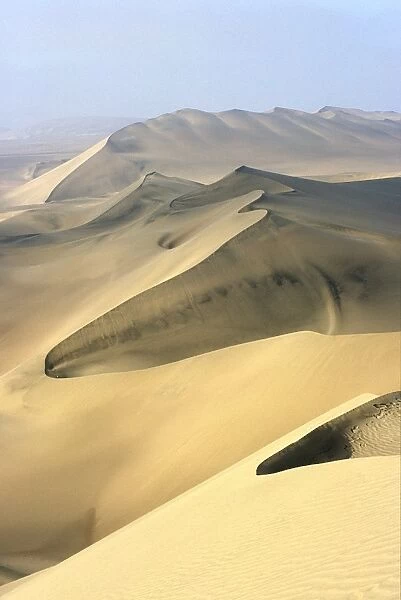 Sand dunes stretch into the distance