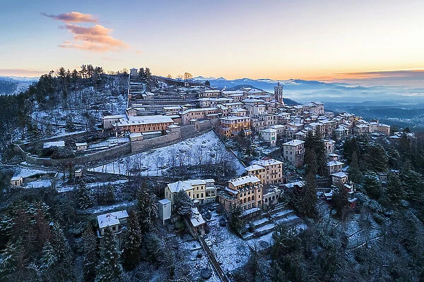 Santa Maria del Monte after a snowfall in winter at sunrise. Varese, Parco Campo dei Fiori, Lombardy, Italy