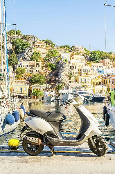 A scooter by the colourful harbour in Symi, Dodecanese Islands, Greece