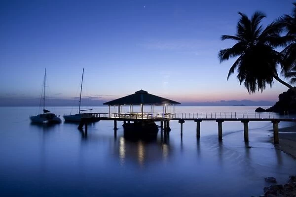 Seychelles, Praslin Island, Anse Bois de Rose, pier at the Coco de Mer hotel, sunset