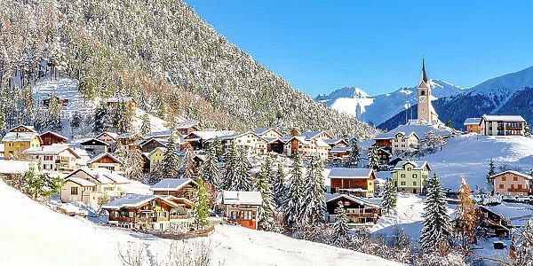 Snowy woods and mountains framing the alpine village of Alvaneu in winter, Davos, Graubunden canton, Switzerland
