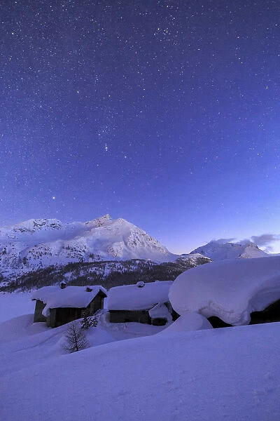 The stars shine above Spluga, Maloja Pass. Engadine. Switzerland. Europe