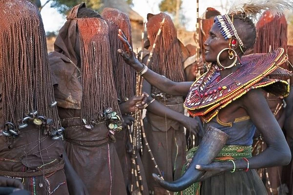 At the start of a Ngetunogh ceremony, the mothers of Pokot initiates will smear animal fat on the boys masks as a blessing. The boys must wear goatskins, conceal their faces with masks made from wild sisal (sansevieria) and carry bows with