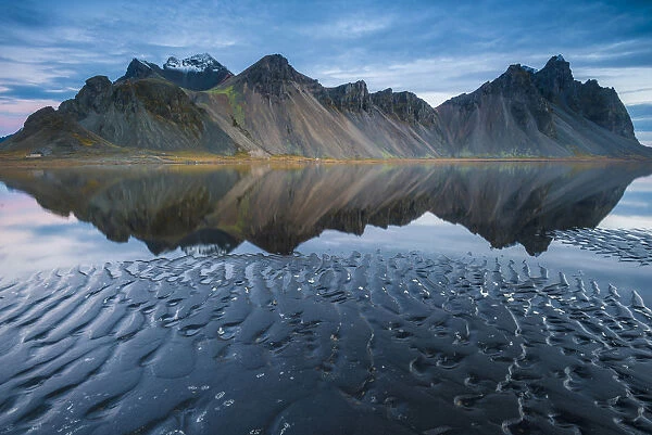 Stokksnes, Iceland. Vestrahorn mountain mirrors in the waters of the Stokksnes bay