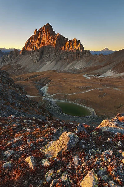 Sunset in mountains landscape, with Rocca la Meja peak, and an alpines lake